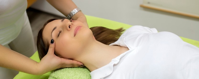 chiropractor in Miami evaluating patient with chronic headaches and neck tension